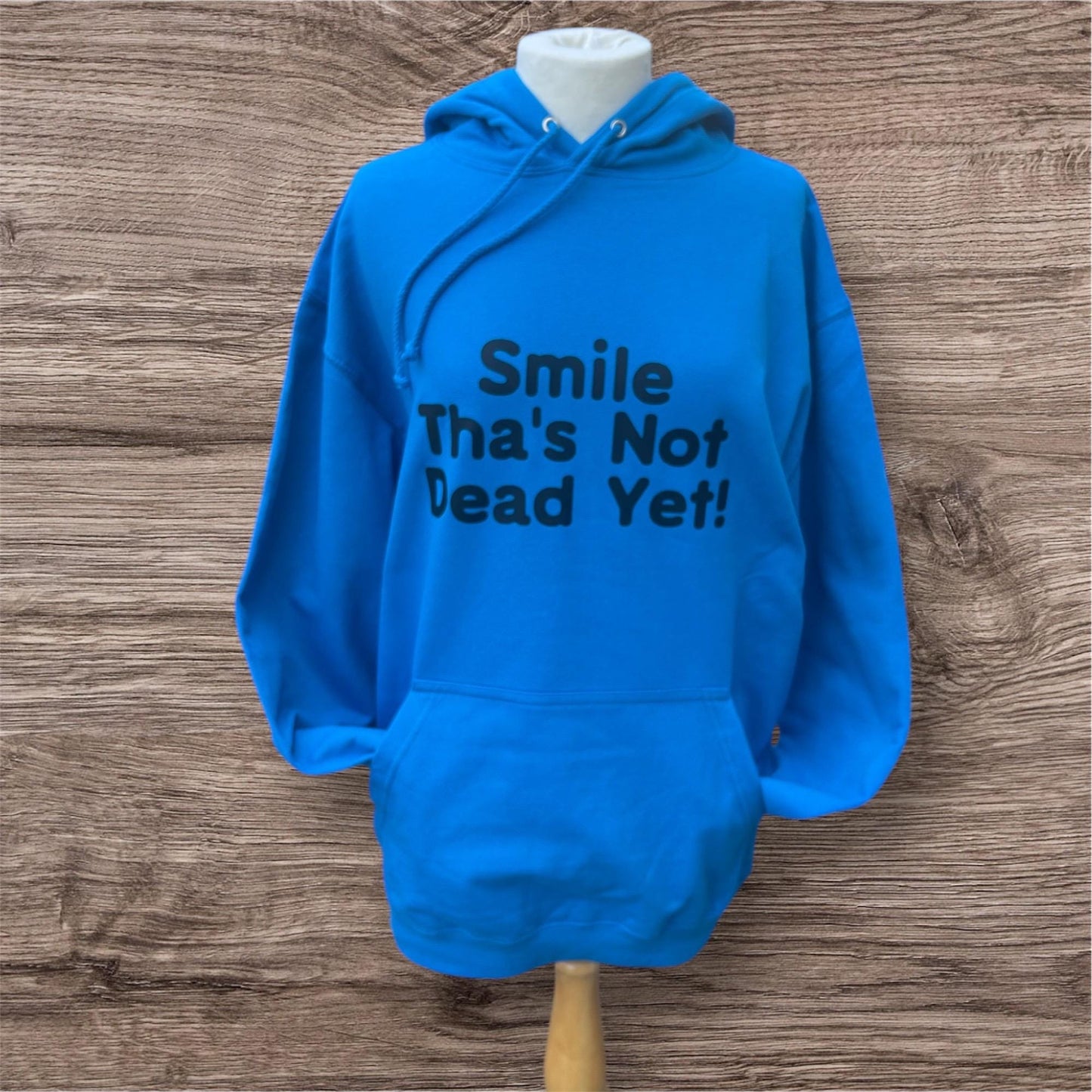 Blue hoodie with 'Smile That's Not Dead Yet!' text on  great gift