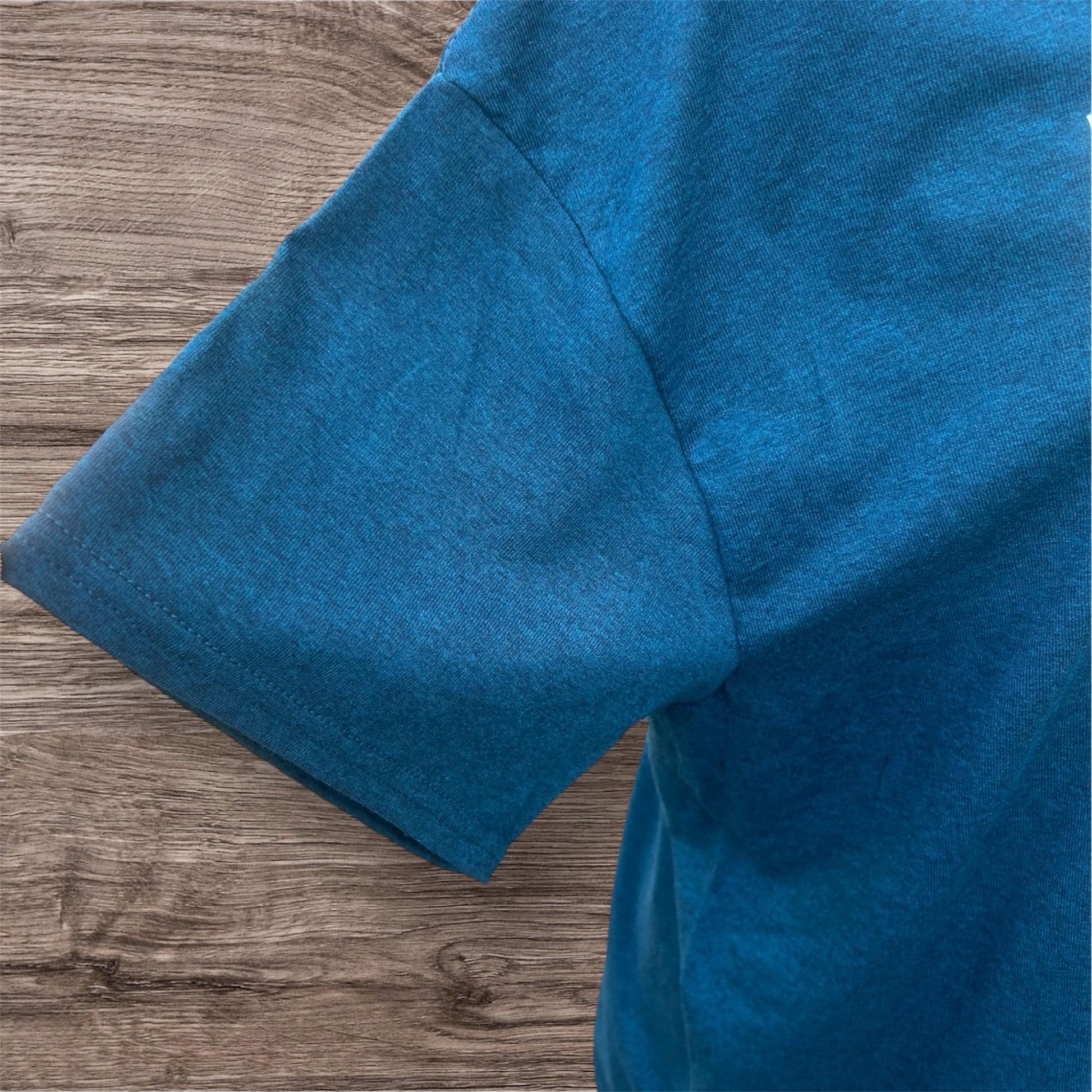 Close-up of a blue fabric sleeve on a T shirt