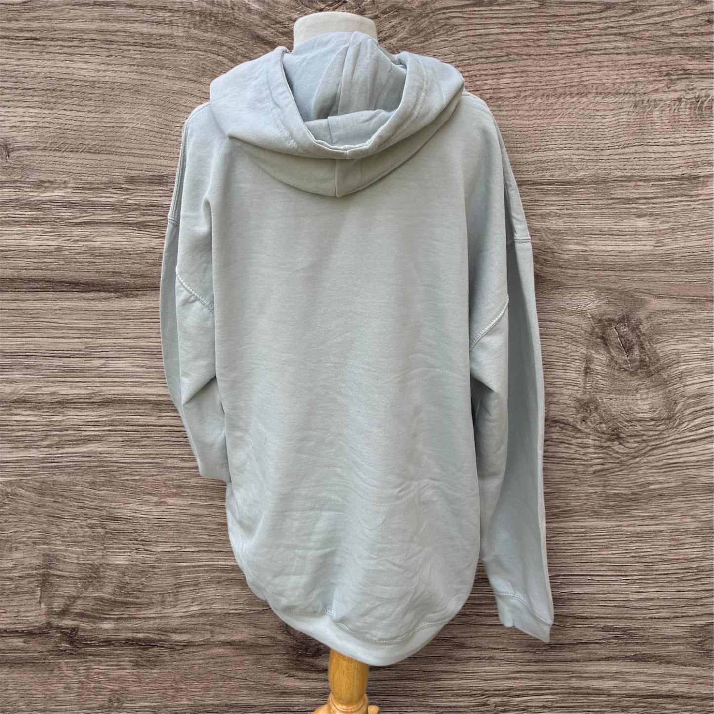 Light gray hoodie on a wooden mannequin with Yorlshire slang on the front